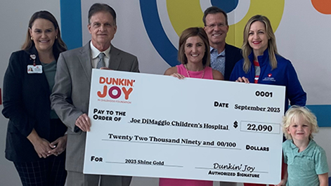 Joe D 2023 Dunkin' check presentation with Caitlin and Kevin