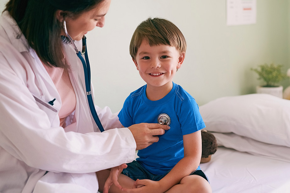 Doctor with stethoscope and child in hospital 
