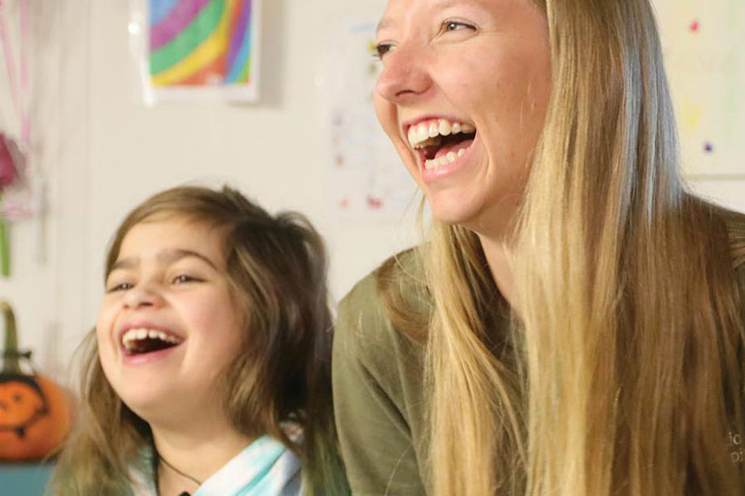 Woman and child laughing together