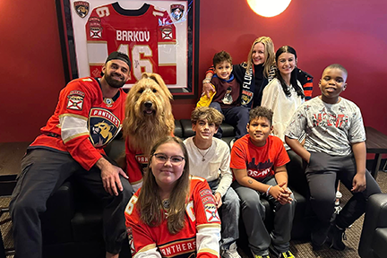Cliff, Brodie, Caitln, and patients at Joe D Florida Panthers party