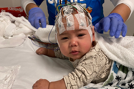 Giovanni wearing electrodes in hospital bed