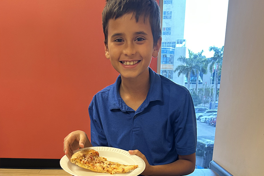Patient Ravi eating a pizza