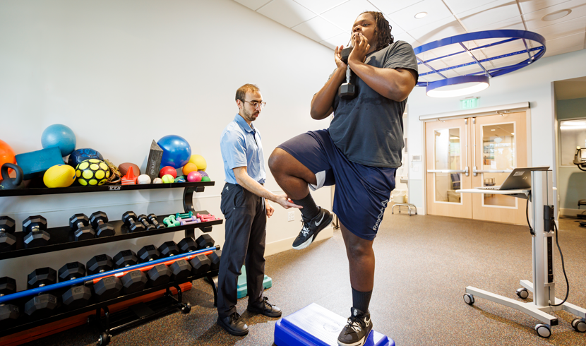 Pediatric Patient with healthcare professional during a sport medicine evaluation and therapy session