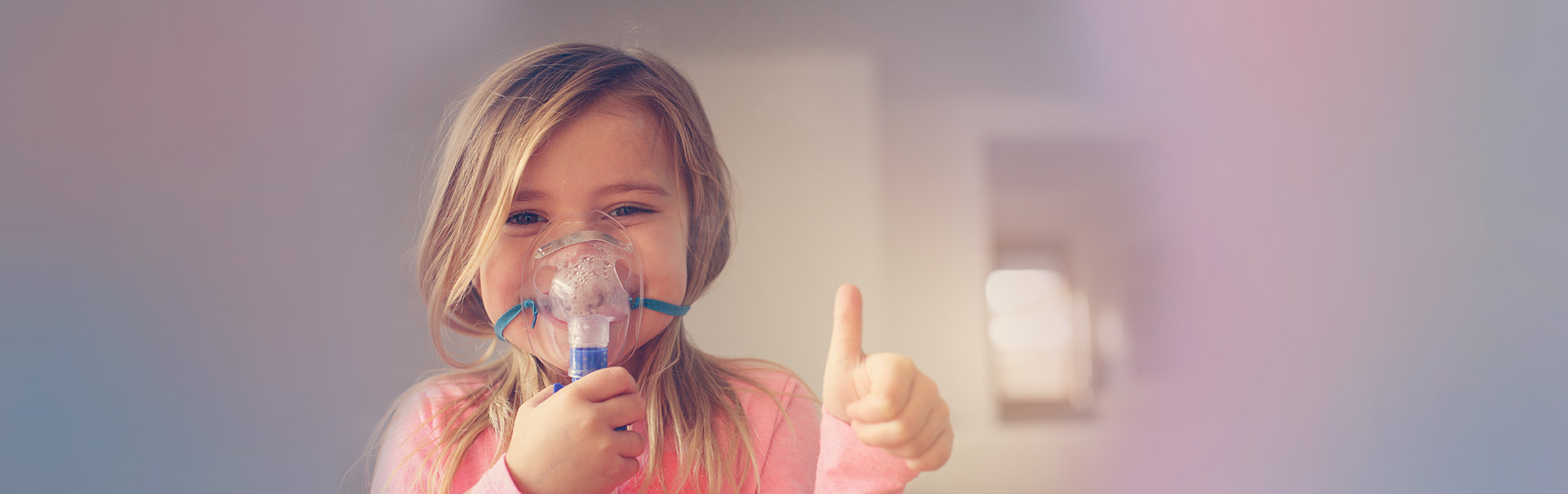 Girl with breathing mask and a thumbs up