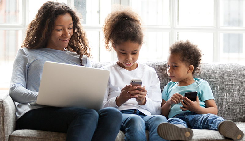 mom and kids using laptop and cell phones