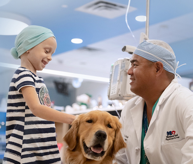 Oliver B Lao, MD with patient and therapy dog