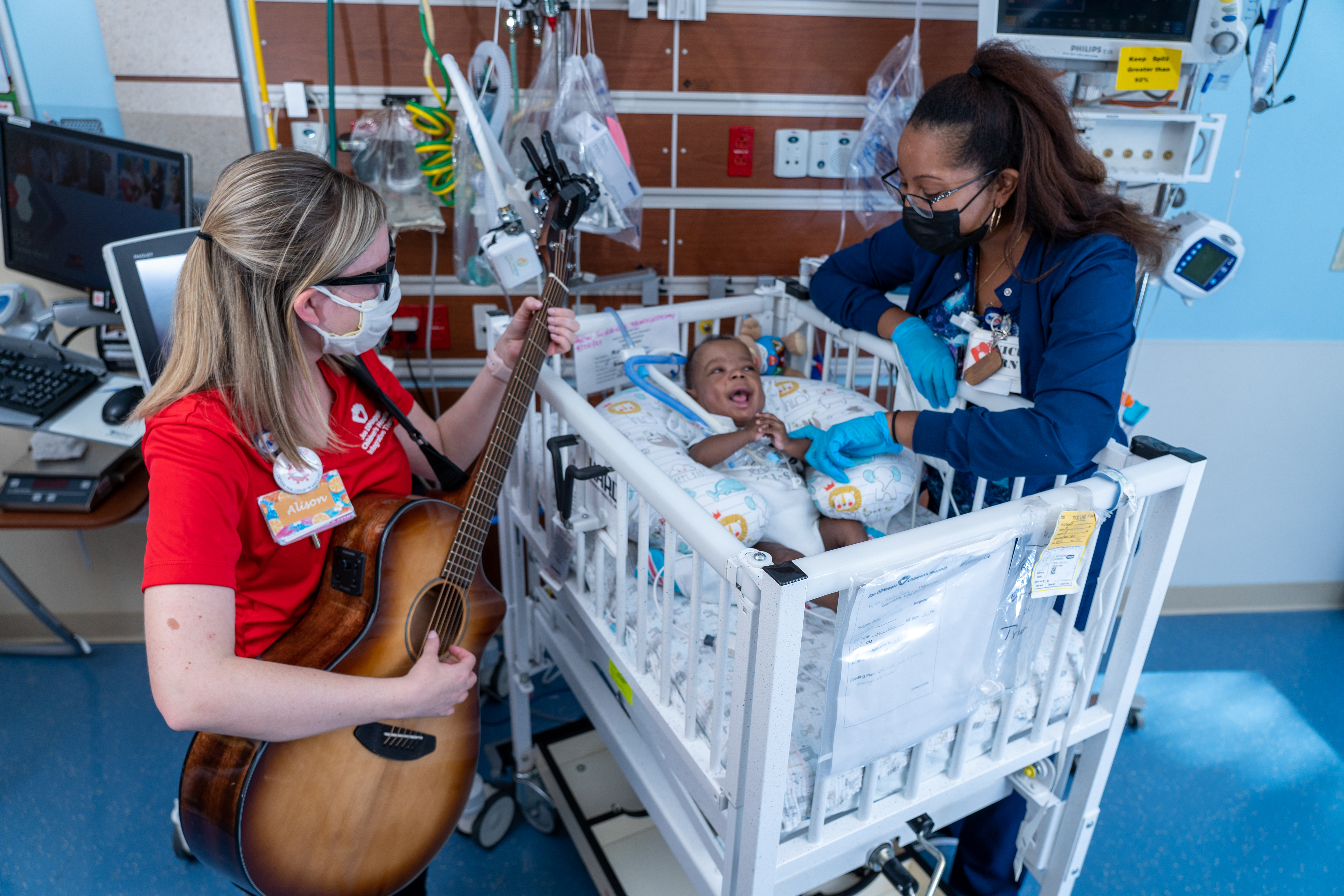 nurse playing guitar to NICU baby BPD
