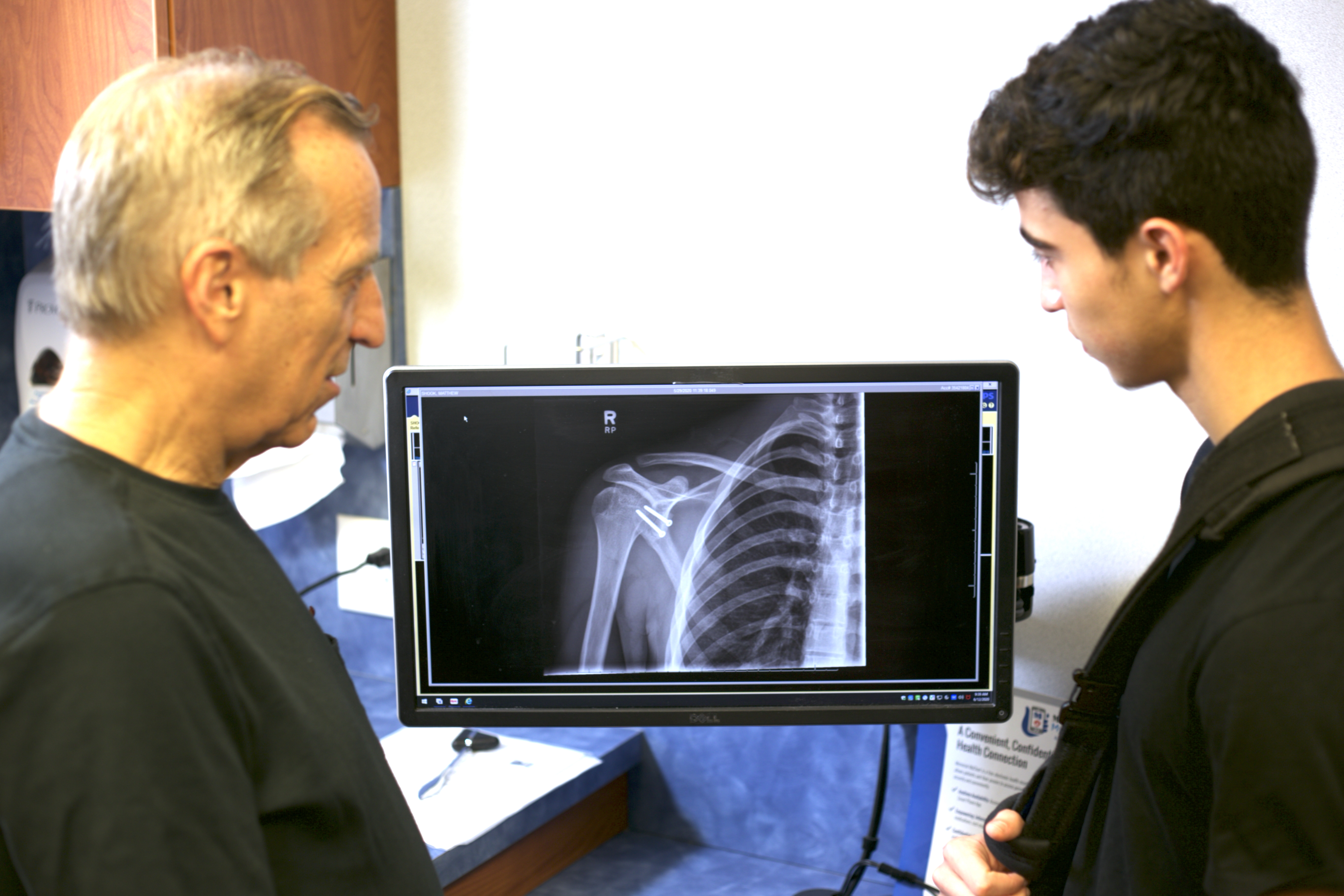 doctor showing patient shoulder image